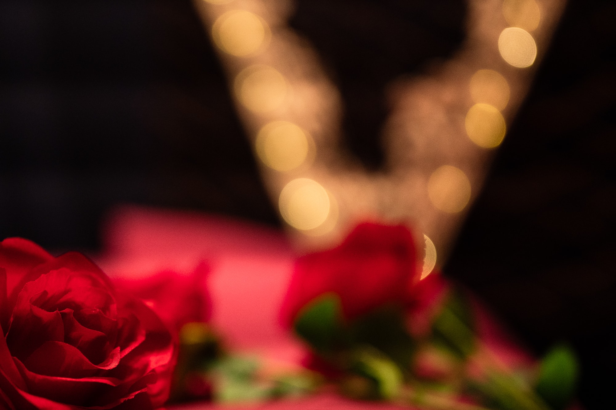 Valentine's Day photography set with roses and a lit up heart behind them